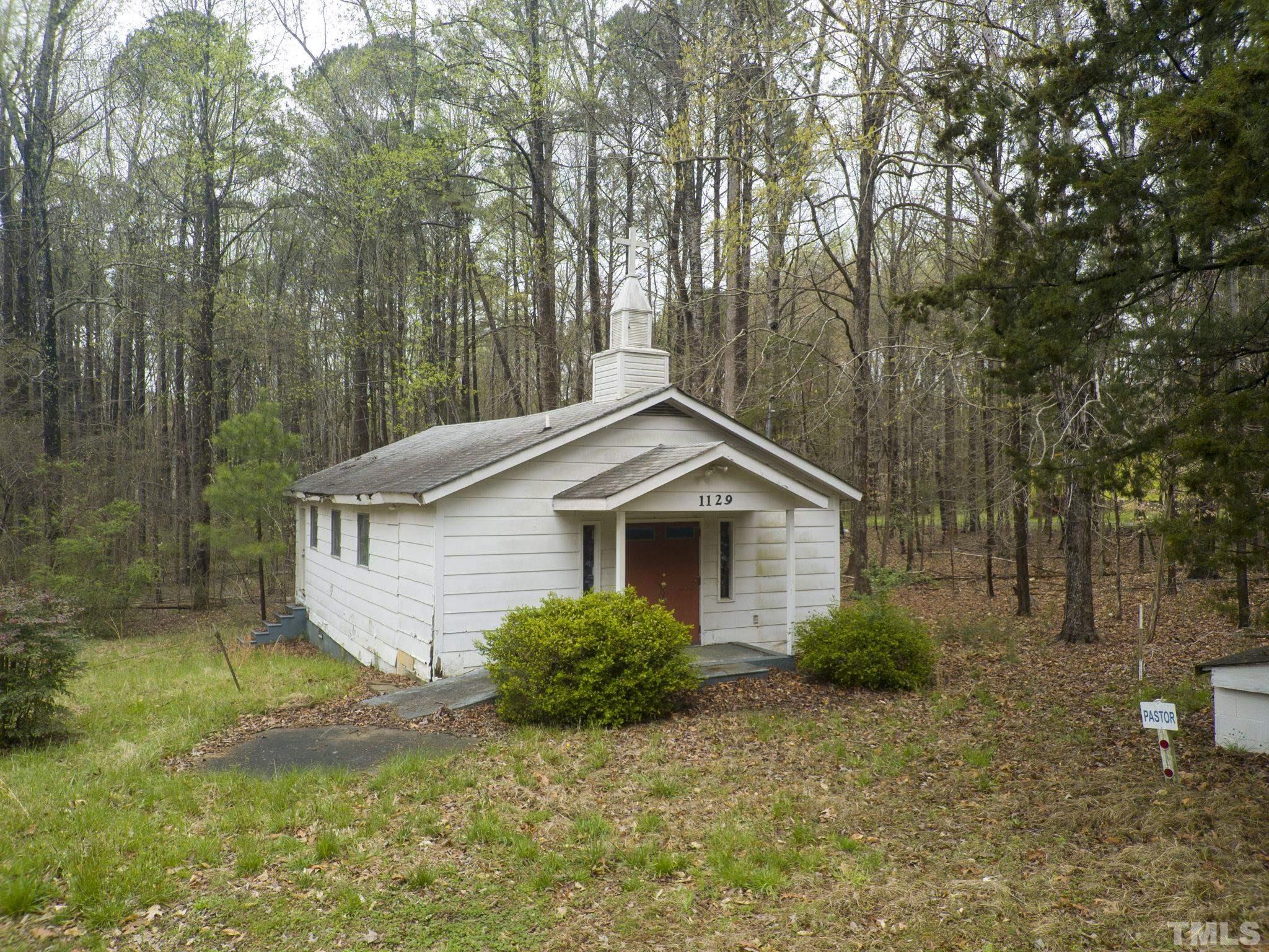 1129 Mt Vernon Church Road Raleigh, NC 27615 - Photo 9 of 11 a house with trees in the background