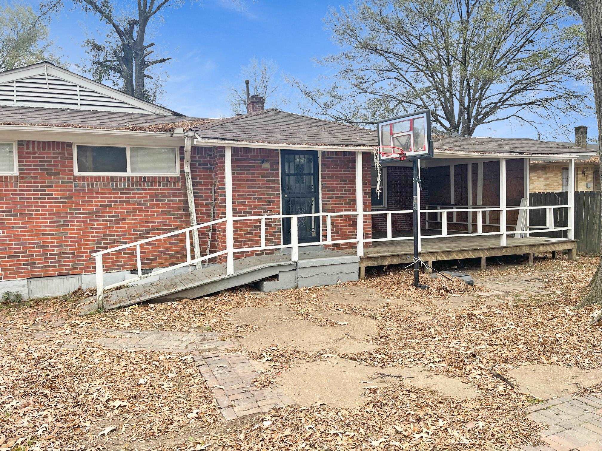 1783 Danville Road Memphis, TN 38117 - Photo 11 of 12 a view of a house with a yard and wooden fence