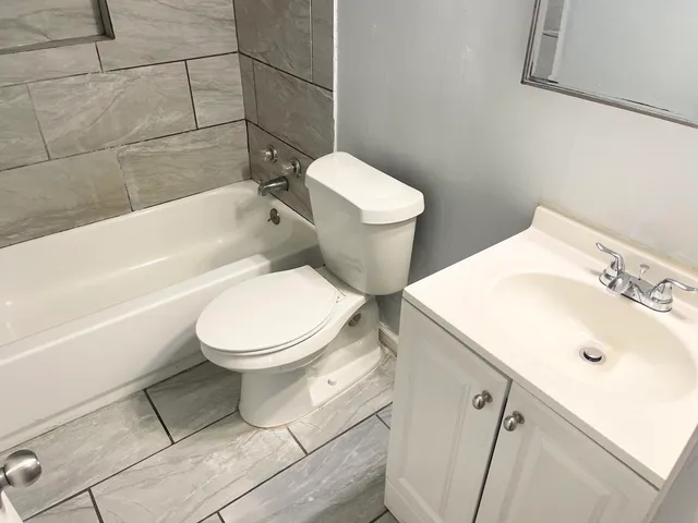 a bathroom with a toilet a sink and bathtub