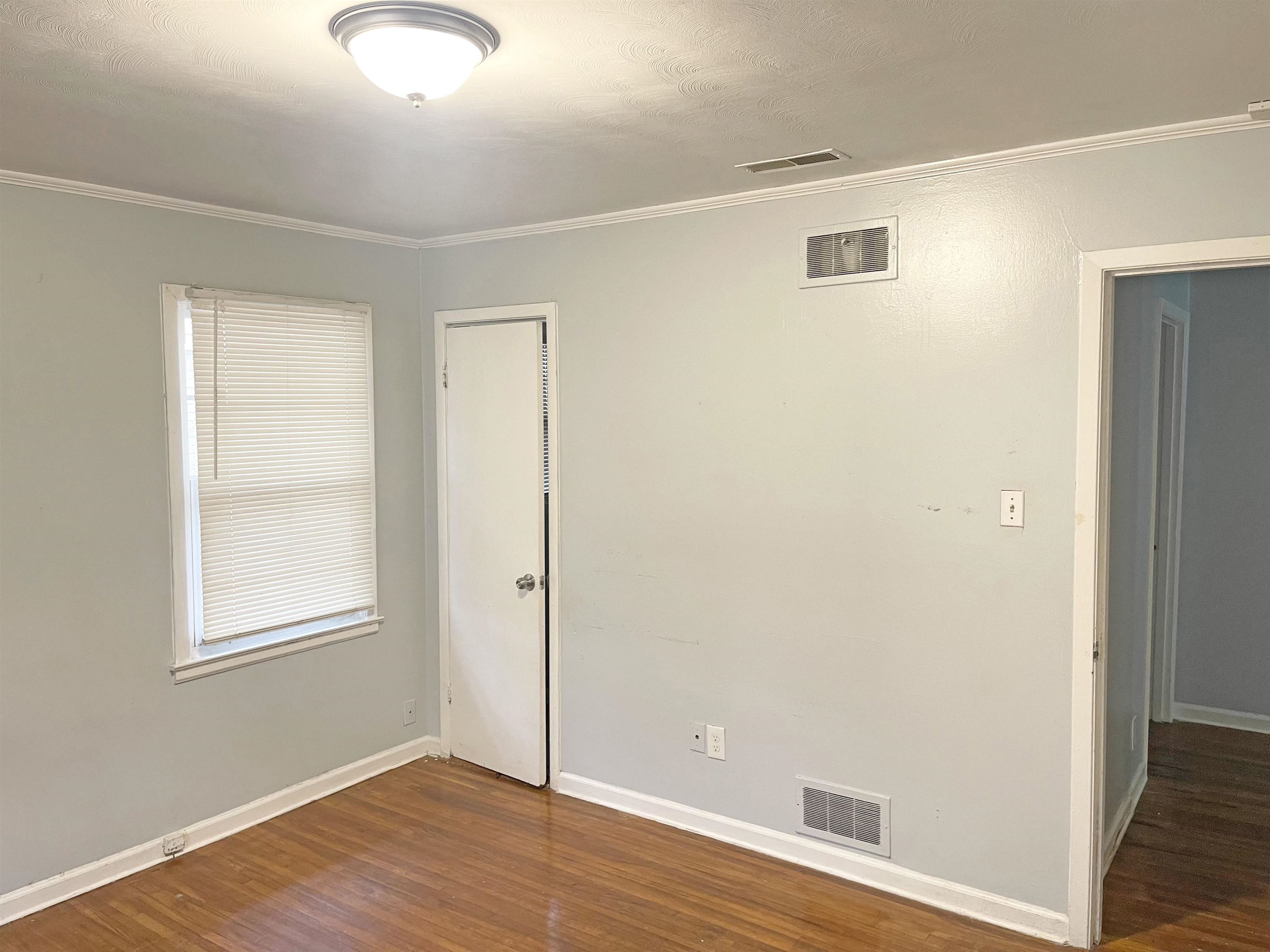 1783 Danville Road Memphis, TN 38117 - Photo 9 of 12 an empty room with wooden floor and windows