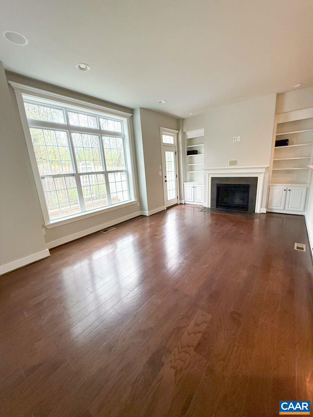 2038 Avinity Loop Charlottesville, VA 22902 - Photo 13 of 36 wooden floor fireplace and windows in an empty room