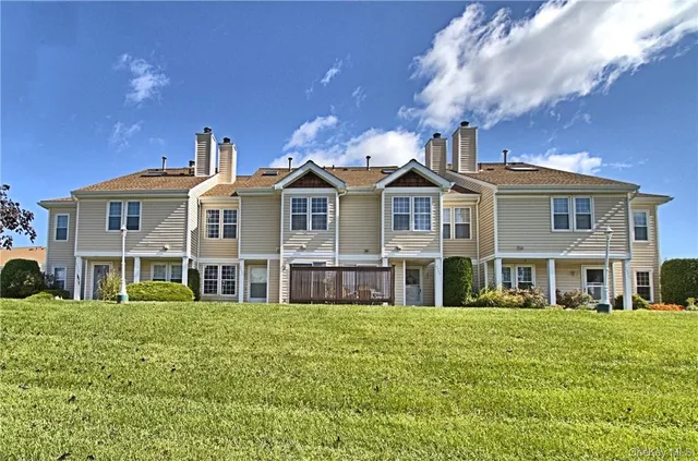 a front view of a building with a yard