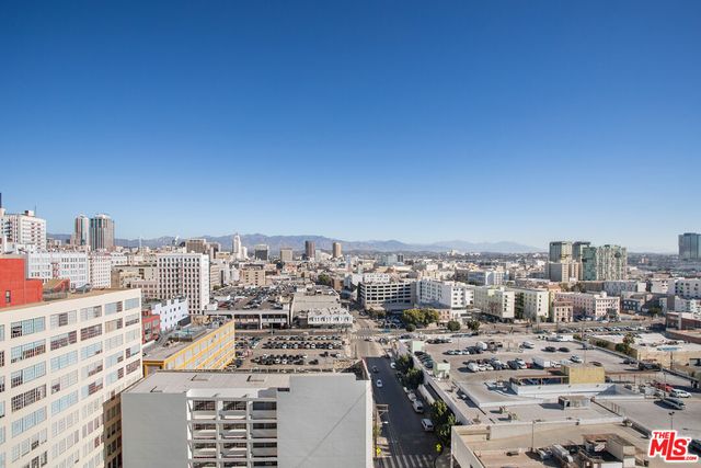a view of a patio with chairs and a potted plant