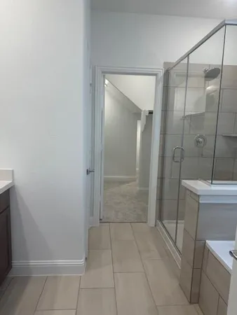a bathroom with a shower and toilet
