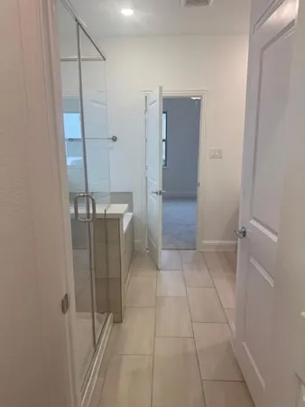 a bathroom with a shower and closet