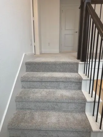 a view of staircase with white walls