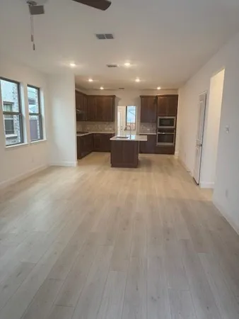 a kitchen with a sink a stove and cabinets