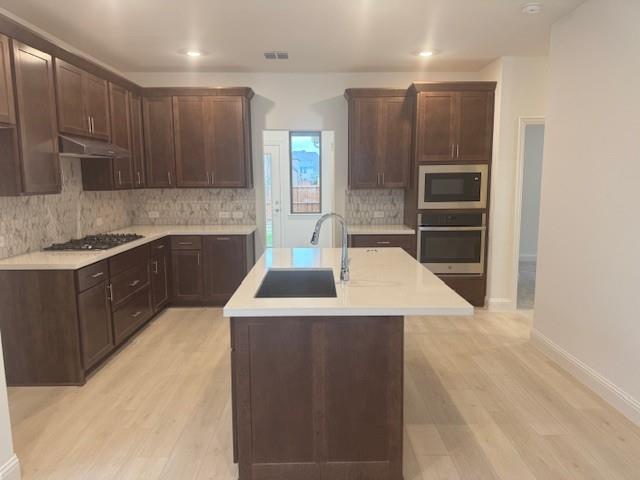 3108 Windecup Road Celina, TX 75009 - Photo 5 of 31 a kitchen with a sink a stove and cabinets
