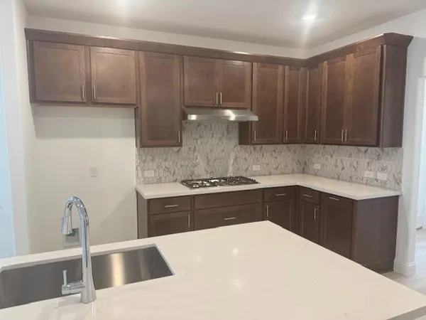 a kitchen with granite countertop cabinets and steel stainless steel appliances
