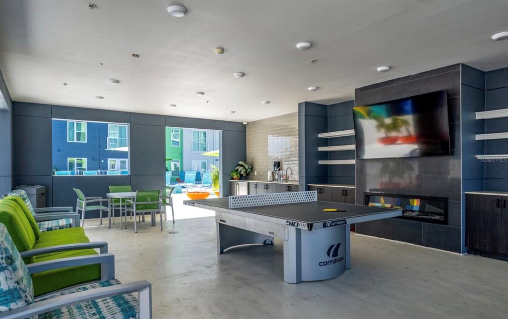 1659 2nd Street, Unit 515 Sarasota, FL 34236 - Photo 15 of 21 a living room with furniture pool table kitchen view and a flat screen tv