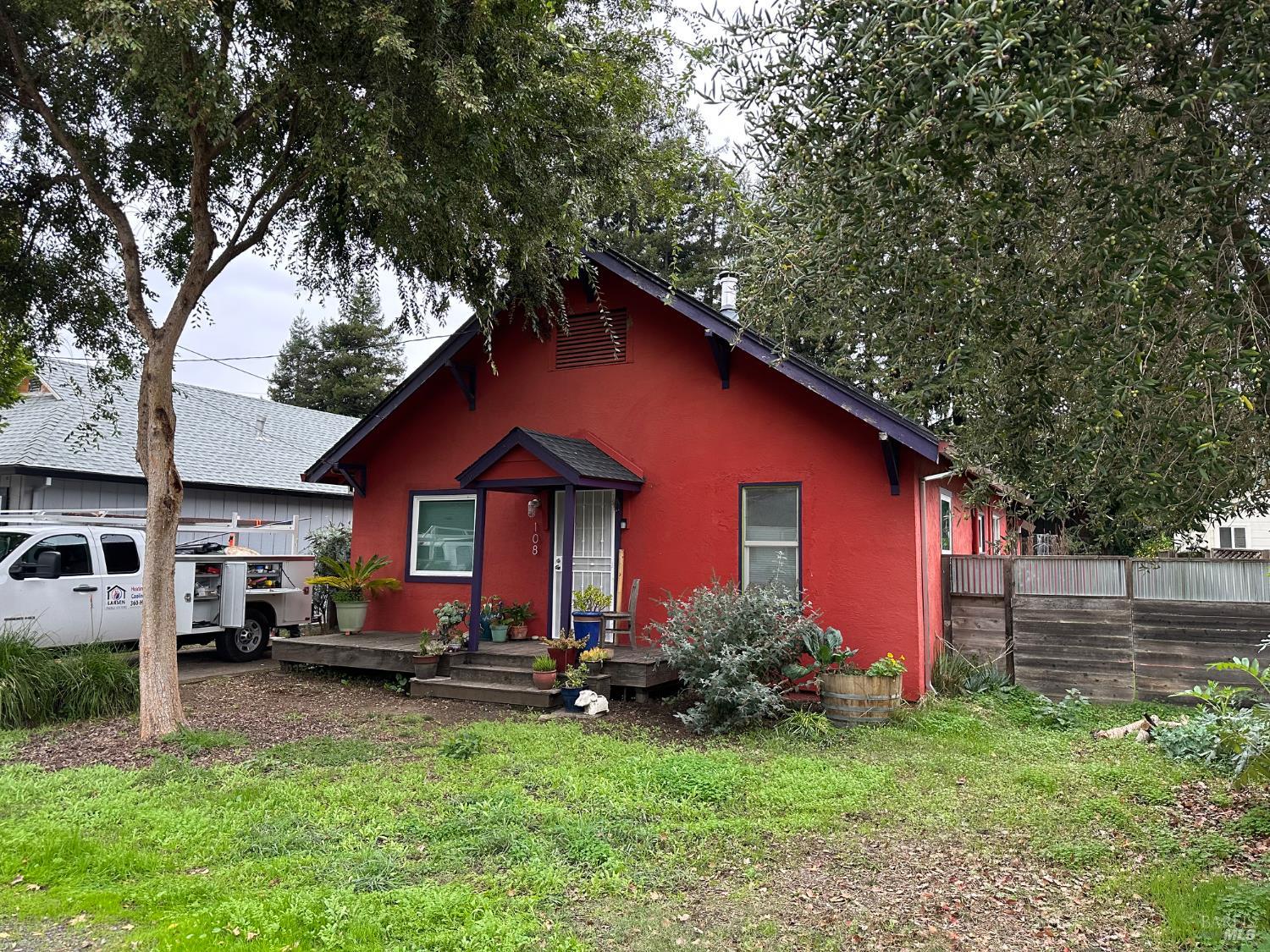 108 Pierson Street Santa Rosa, CA 95401 - Photo 3 of 33 a backyard of a house with table and chairs plants and large tree