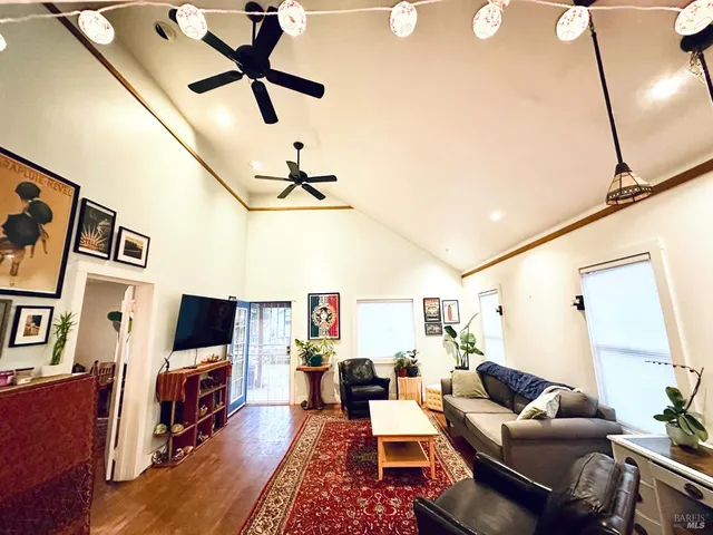 a living room with furniture a flat screen tv and a window
