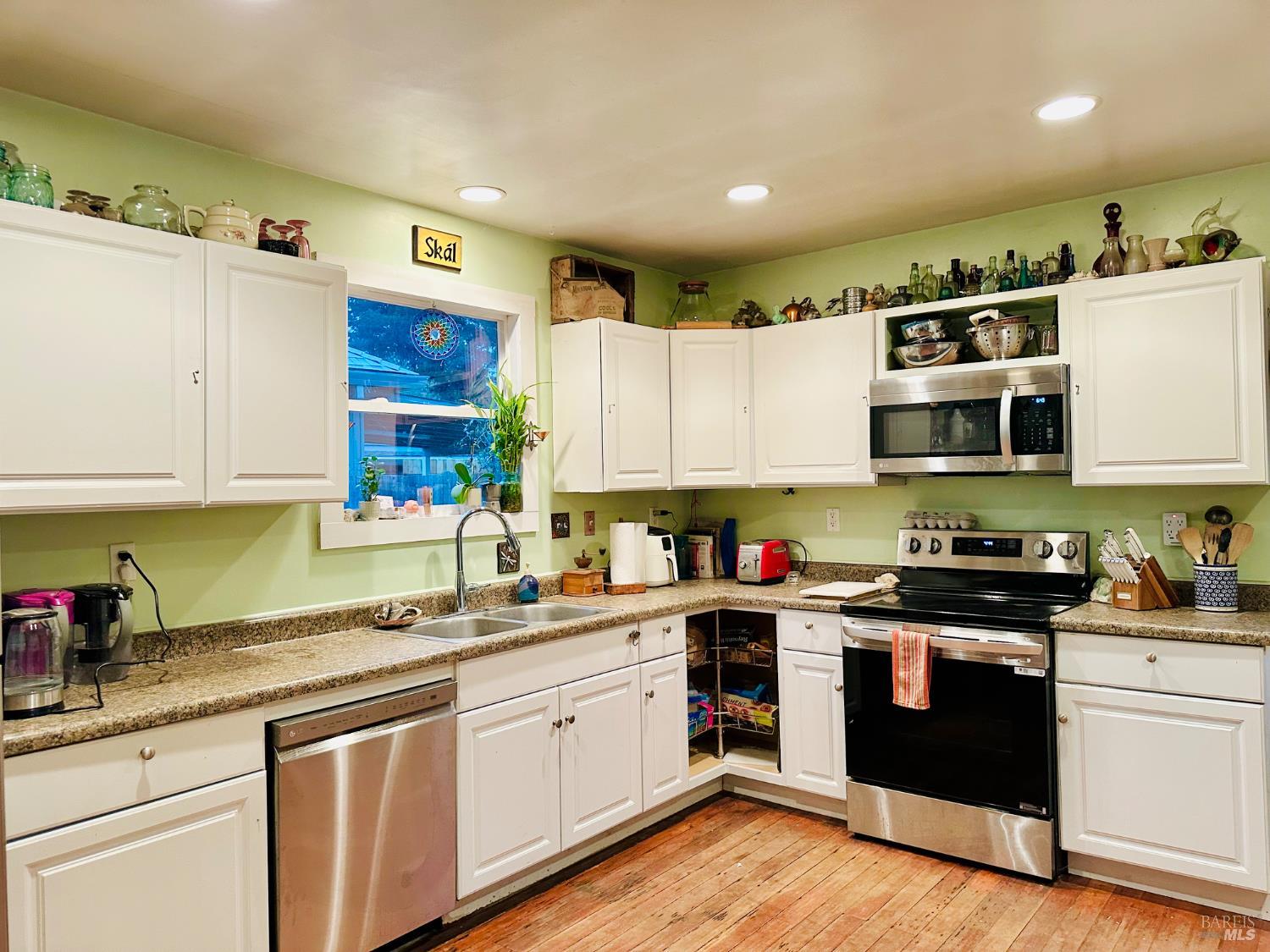 108 Pierson Street Santa Rosa, CA 95401 - Photo 10 of 33 a kitchen with stainless steel appliances granite countertop a stove a sink and white cabinets