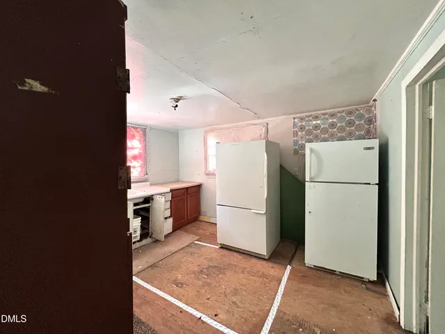 a kitchen with a refrigerator and a stove