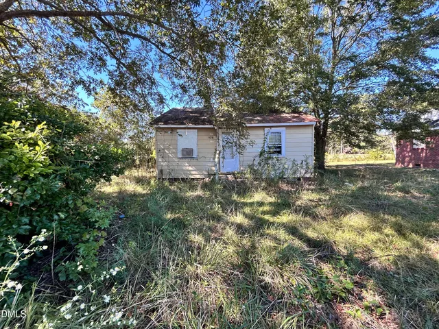 a view of a house with a tree