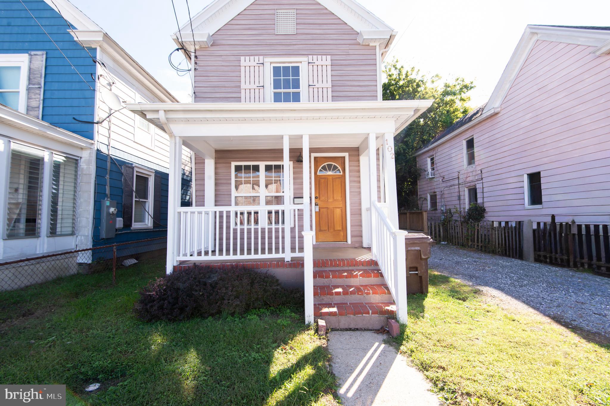 a view of a house with a swimming pool and porch with a bench
