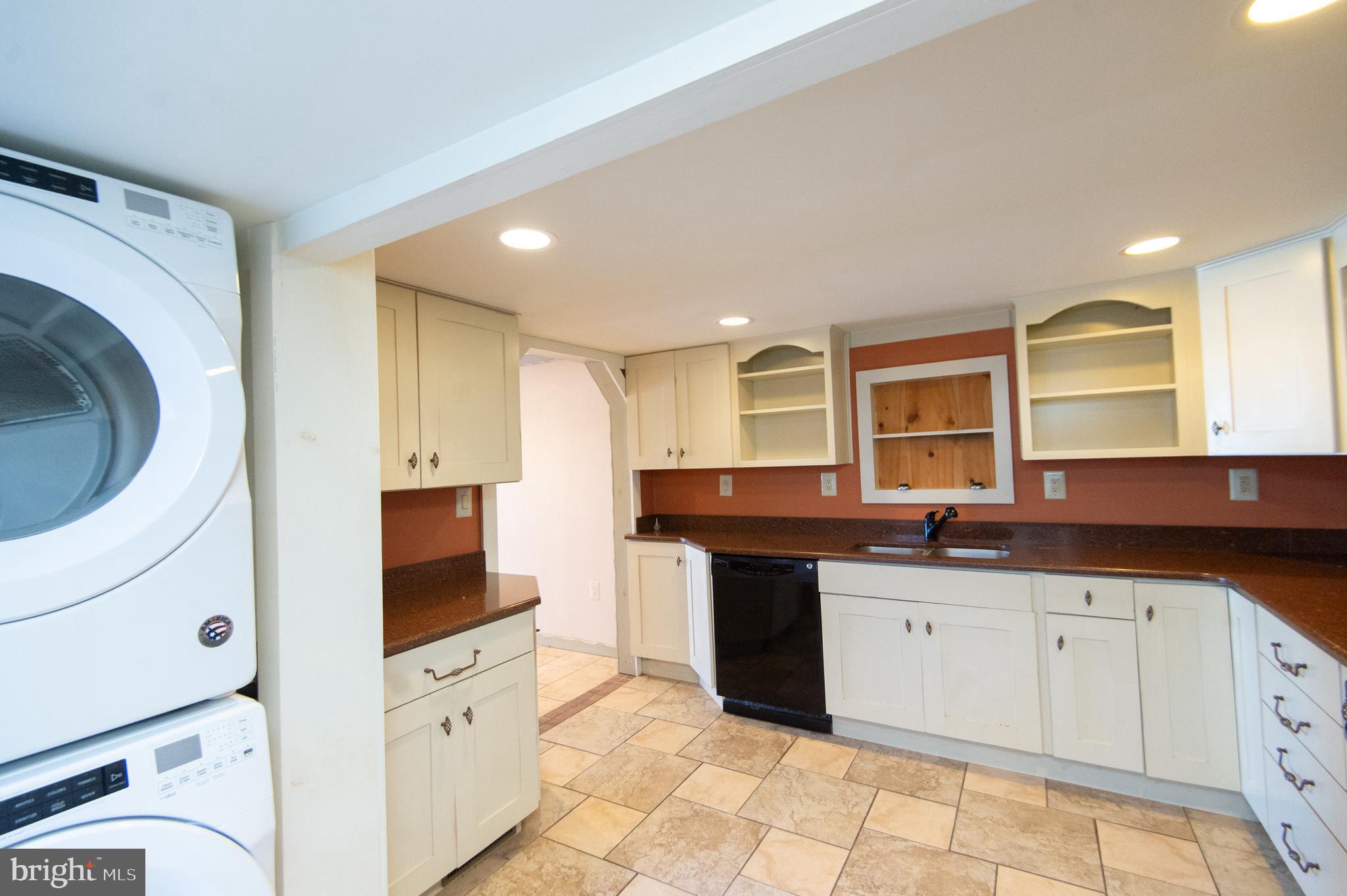 102 Hayward Street Cambridge, MD 21613 - Photo 13 of 35 a kitchen with granite countertop a sink and cabinets