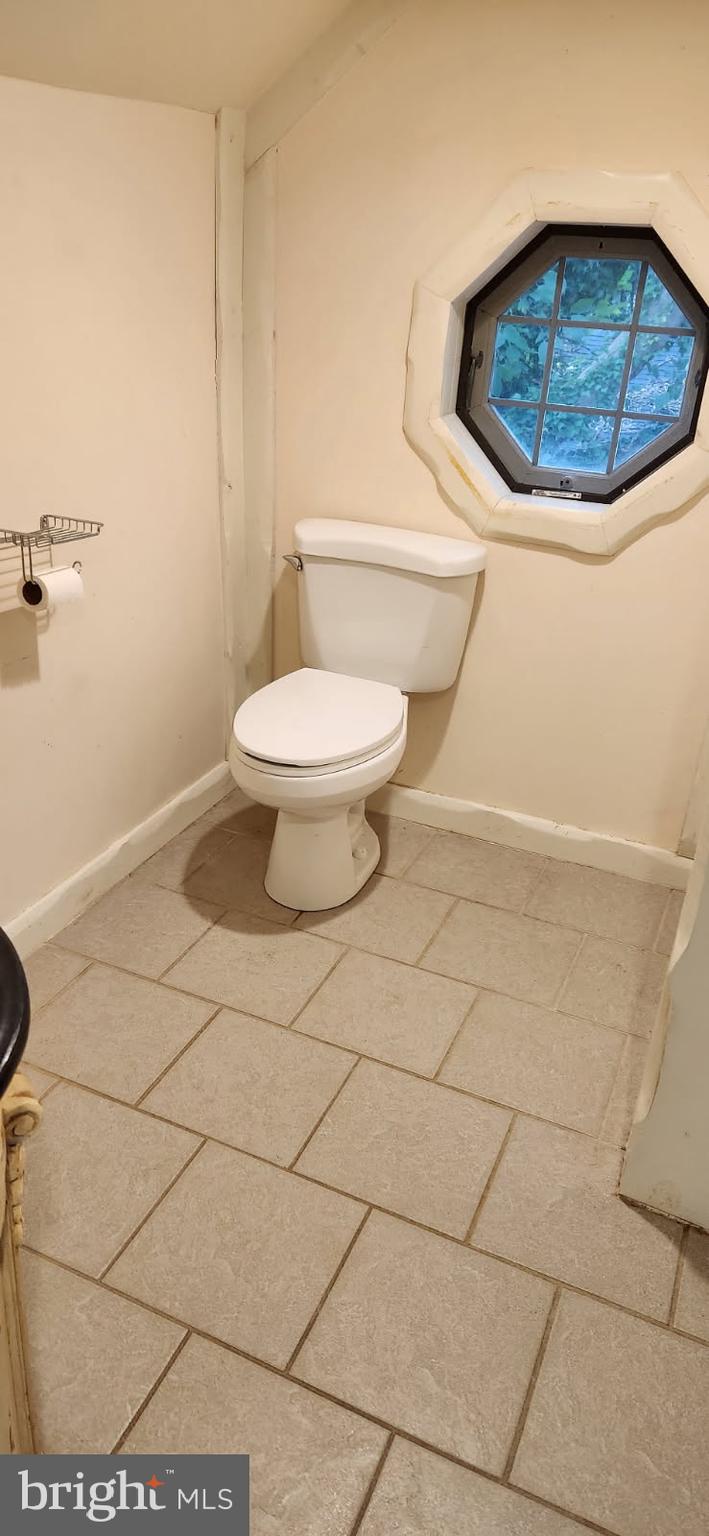 102 Hayward Street Cambridge, MD 21613 - Photo 16 of 35 a bathroom with a toilet and a mirror