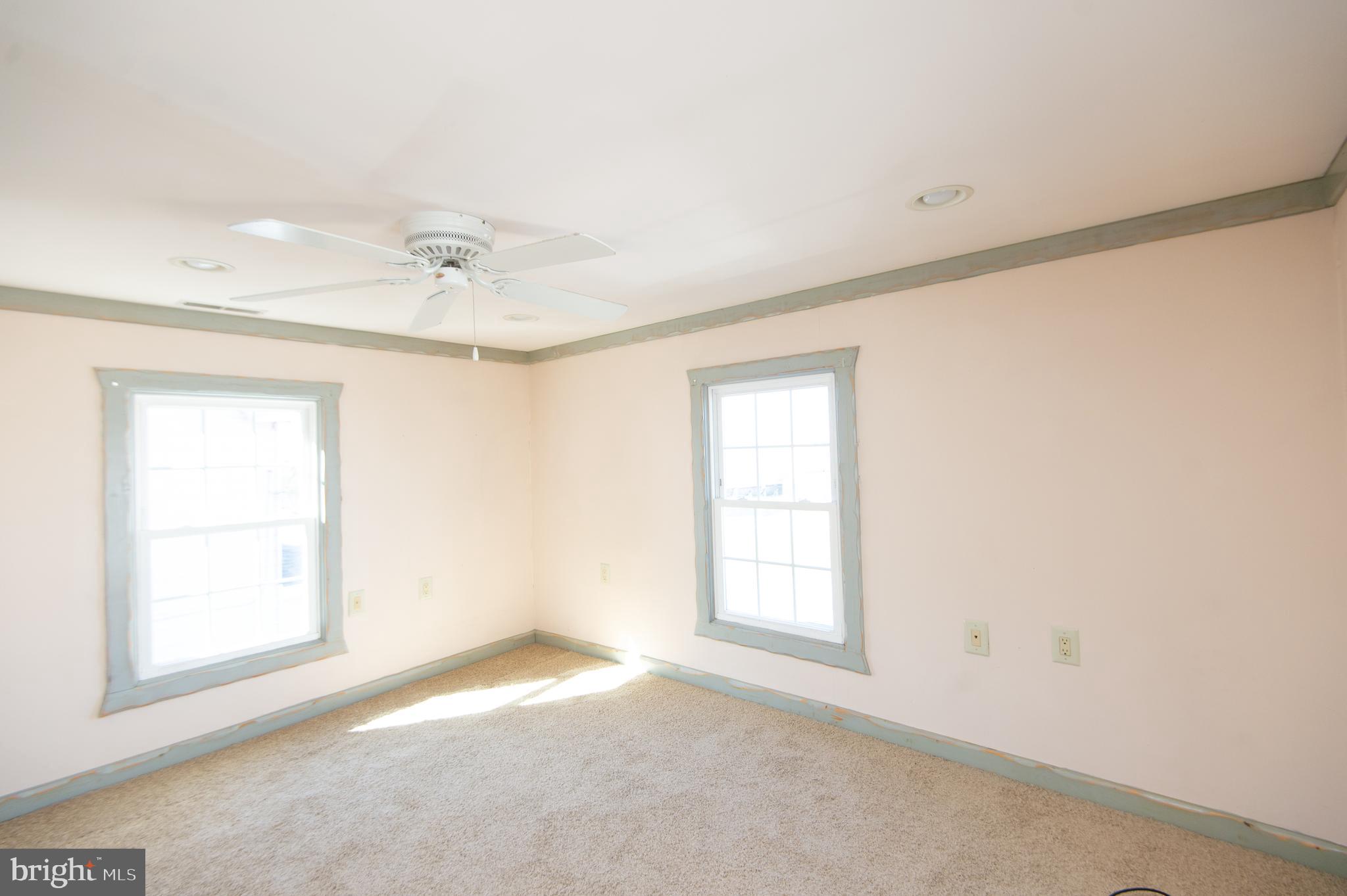 102 Hayward Street Cambridge, MD 21613 - Photo 23 of 35 an empty room with windows and fan