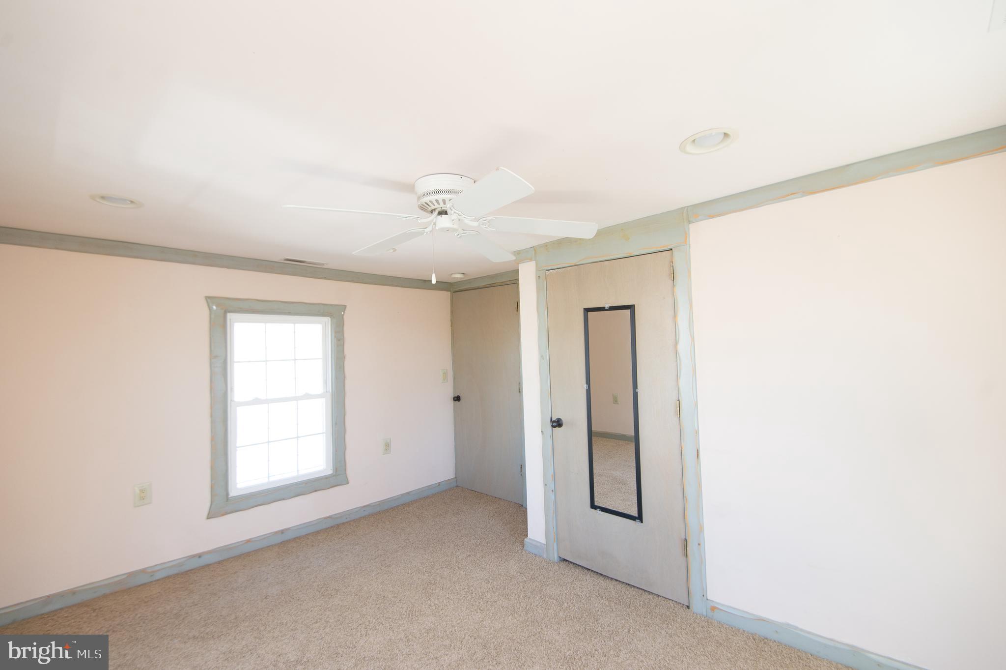 102 Hayward Street Cambridge, MD 21613 - Photo 25 of 35 an empty room with windows and closet