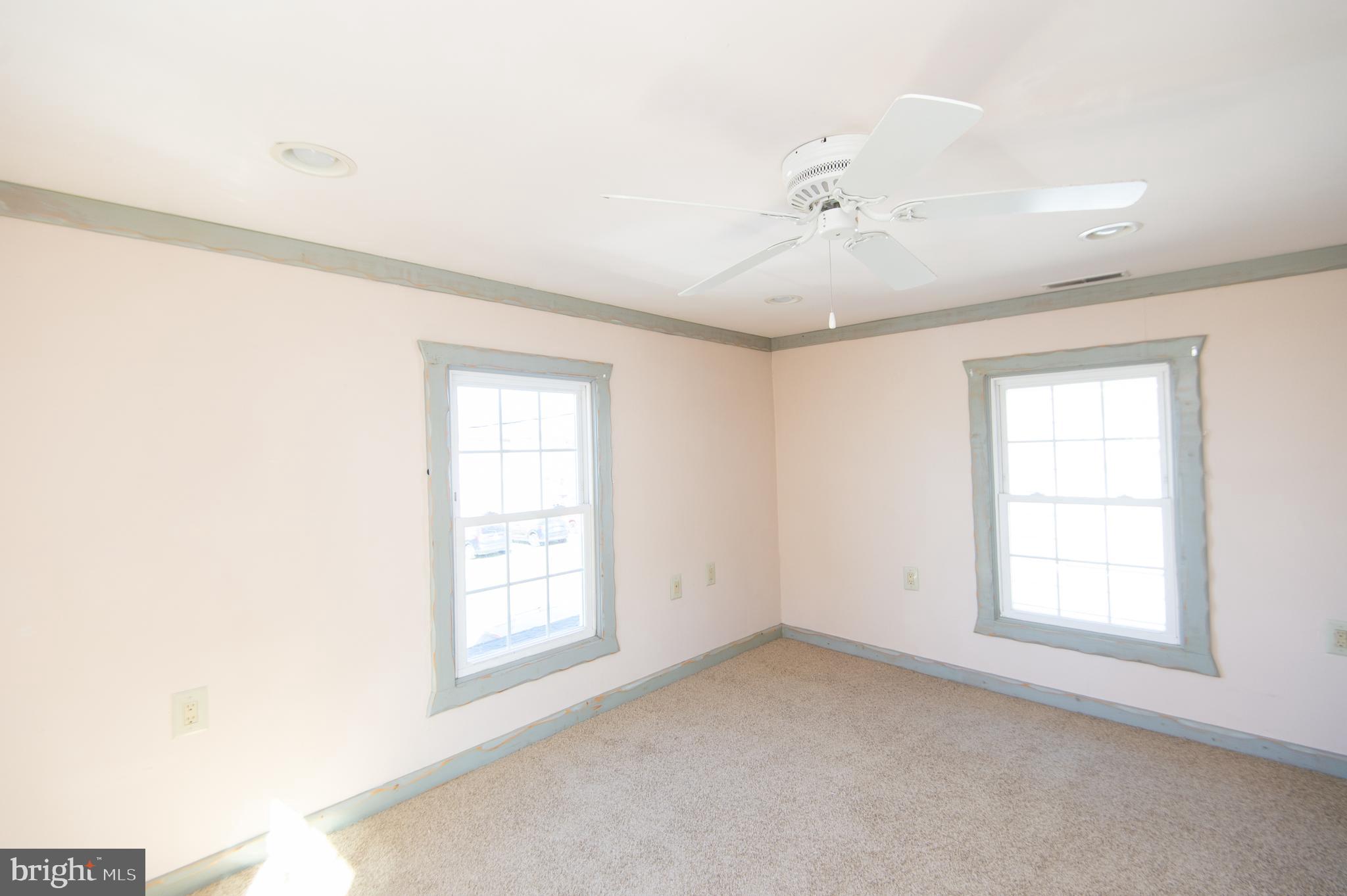 102 Hayward Street Cambridge, MD 21613 - Photo 26 of 35 an empty room with windows and cabinet