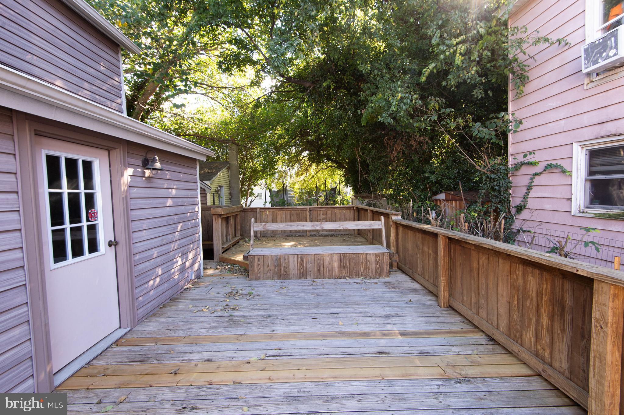 102 Hayward Street Cambridge, MD 21613 - Photo 30 of 35 a view of outdoor space with deck and wooden fence