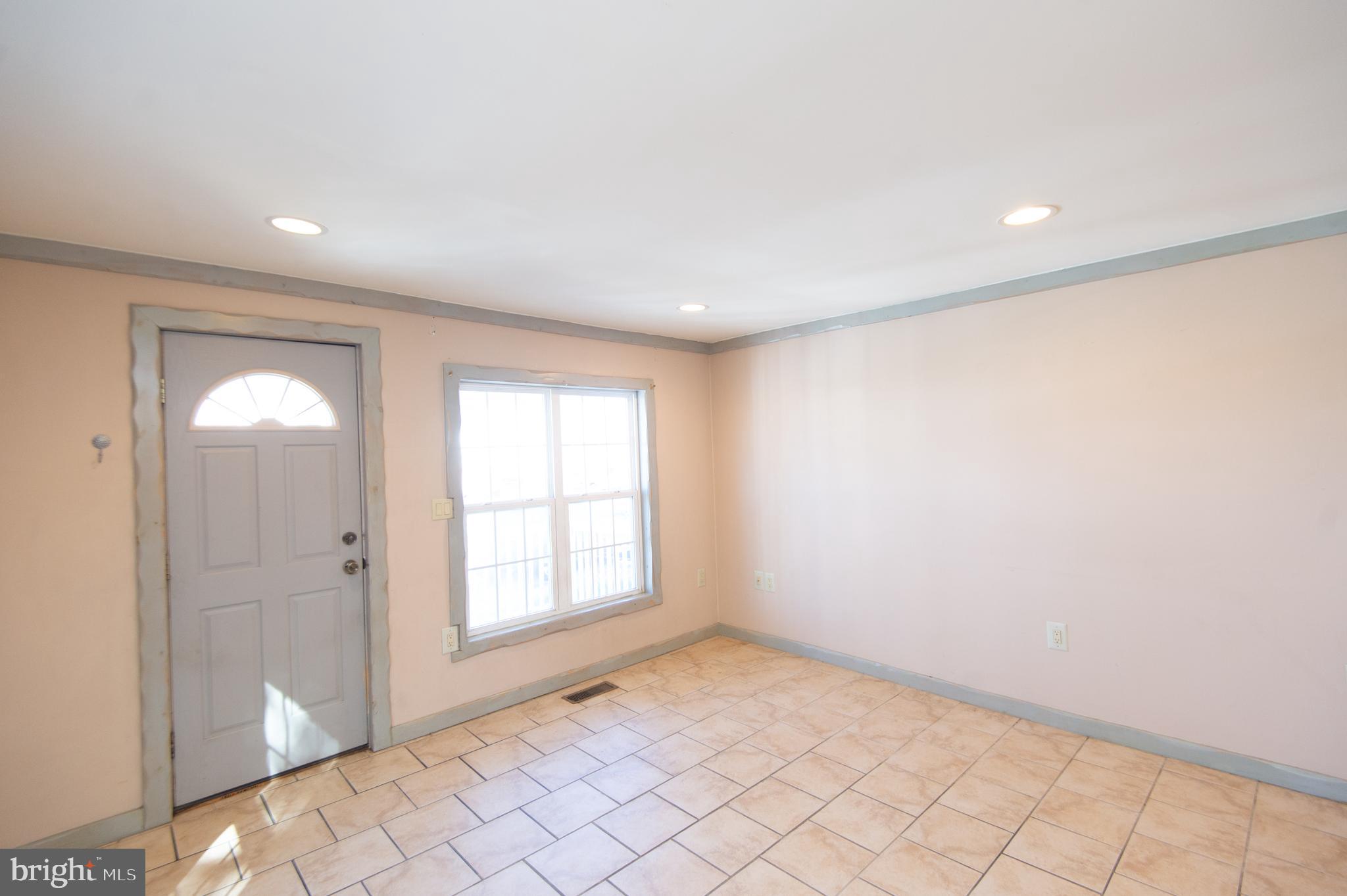102 Hayward Street Cambridge, MD 21613 - Photo 7 of 35 an empty room with windows