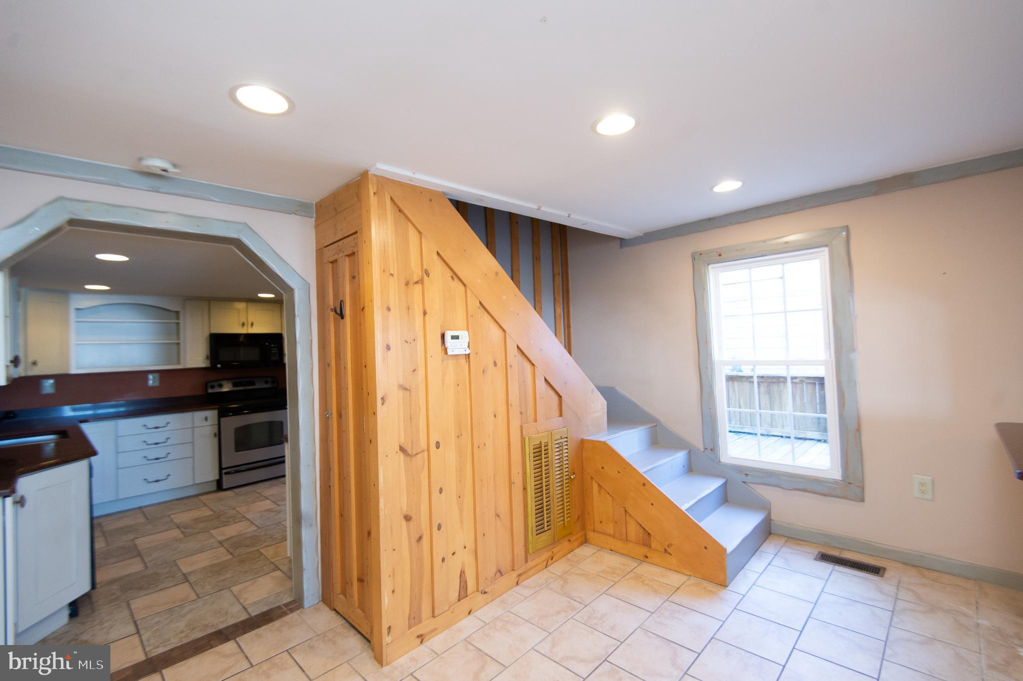 102 Hayward Street Cambridge, MD 21613 - Photo 10 of 35 a view of kitchen with kitchen island granite countertop cabinets and glass door