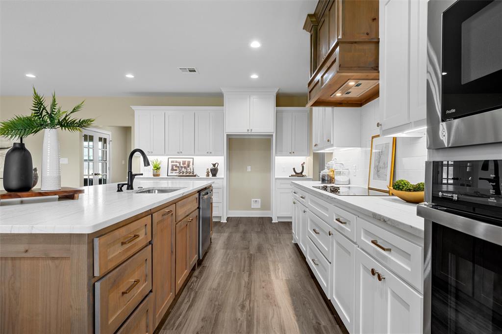 929 Northern Dancer Drive Hewitt, TX 76643 - Photo 5 of 36 a kitchen with stainless steel appliances granite countertop a sink a stove and a refrigerator