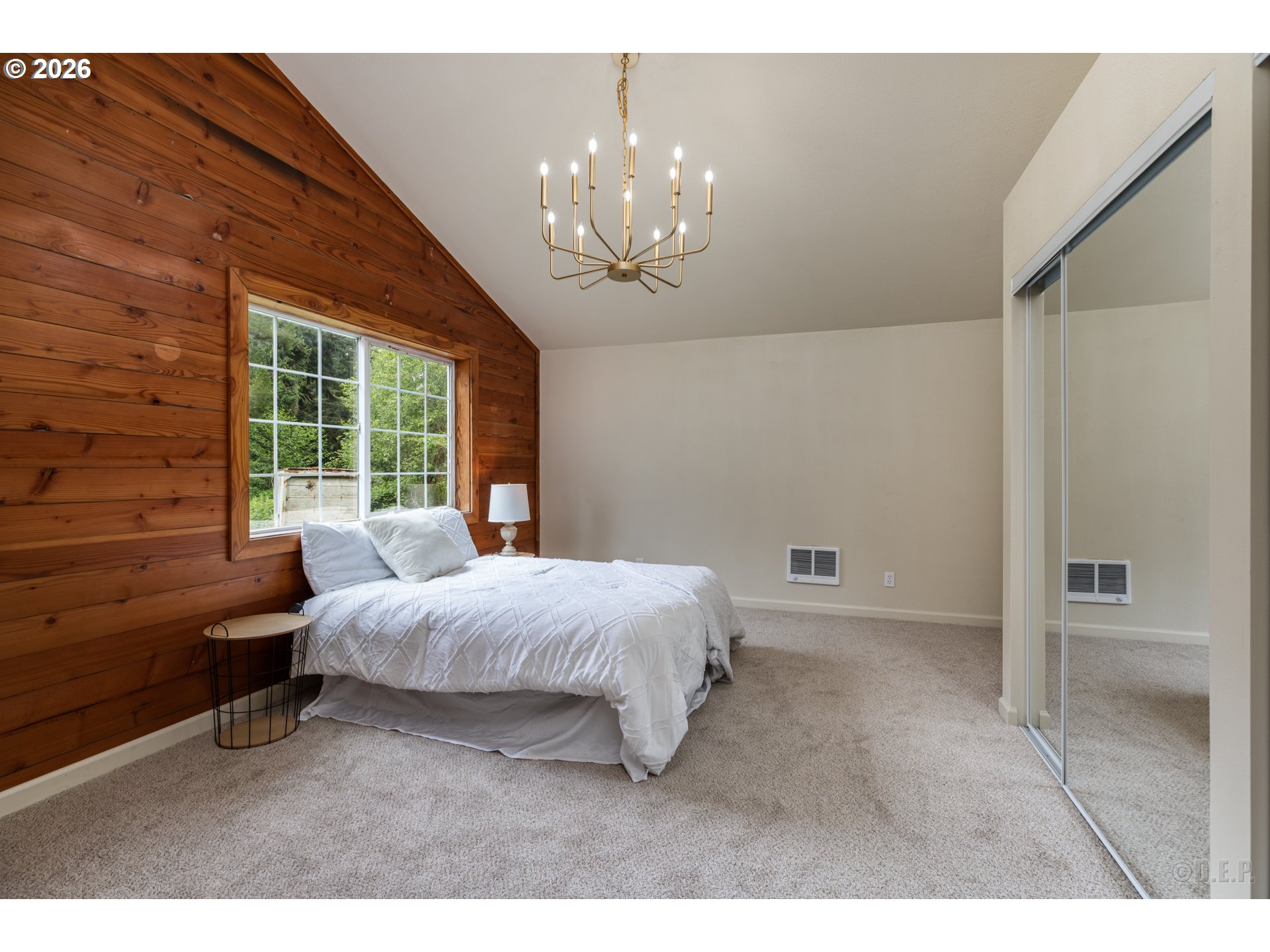 29234 Thistle Hill Road Rainier, OR 97048 - Photo 13 of 33 a spacious bedroom with a bed and a chandelier