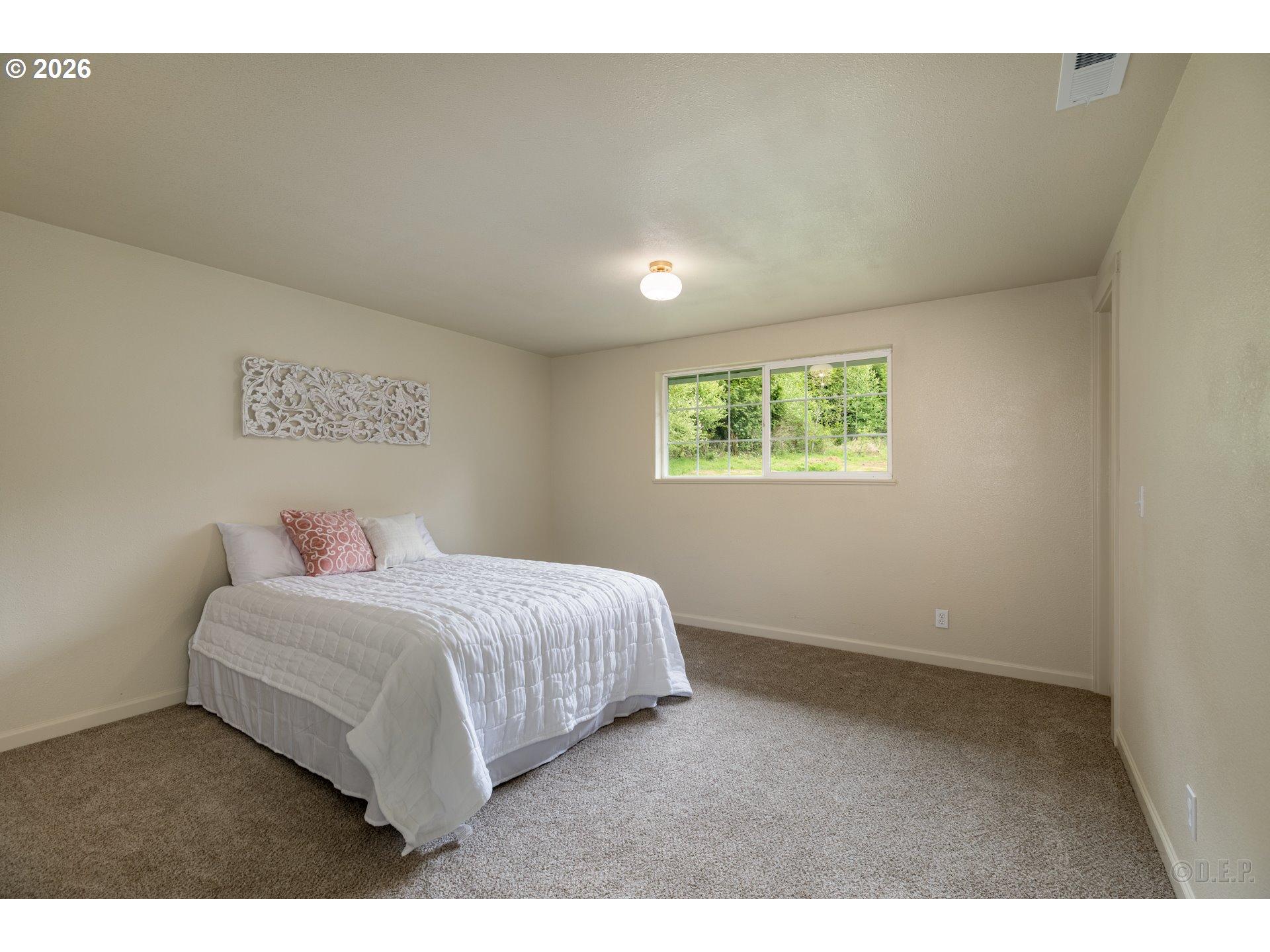29234 Thistle Hill Road Rainier, OR 97048 - Photo 16 of 33 a bedroom with a large bed and a window