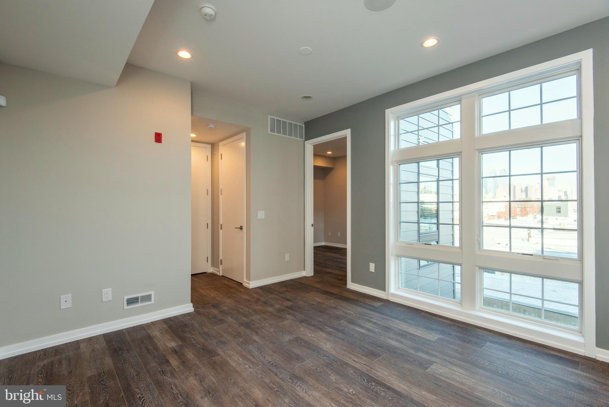 1340 South 13th Street, Unit 3B Philadelphia, PA 19147 - Photo 12 of 31 wooden floor in an empty room with a window