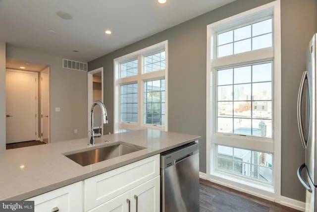 a kitchen with a sink and large window