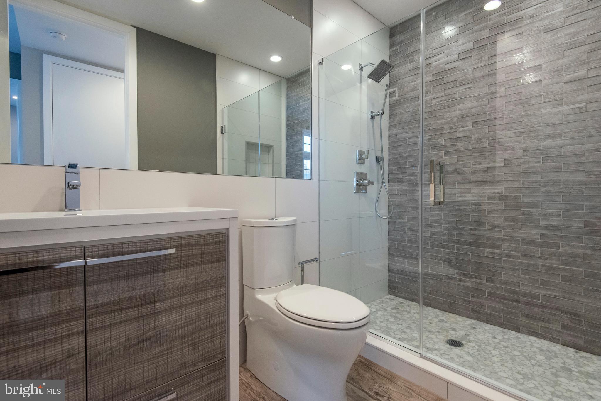 1340 South 13th Street, Unit 3B Philadelphia, PA 19147 - Photo 17 of 31 a bathroom with a sink a toilet and shower