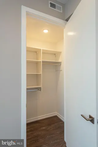 a view of a room with wooden floor