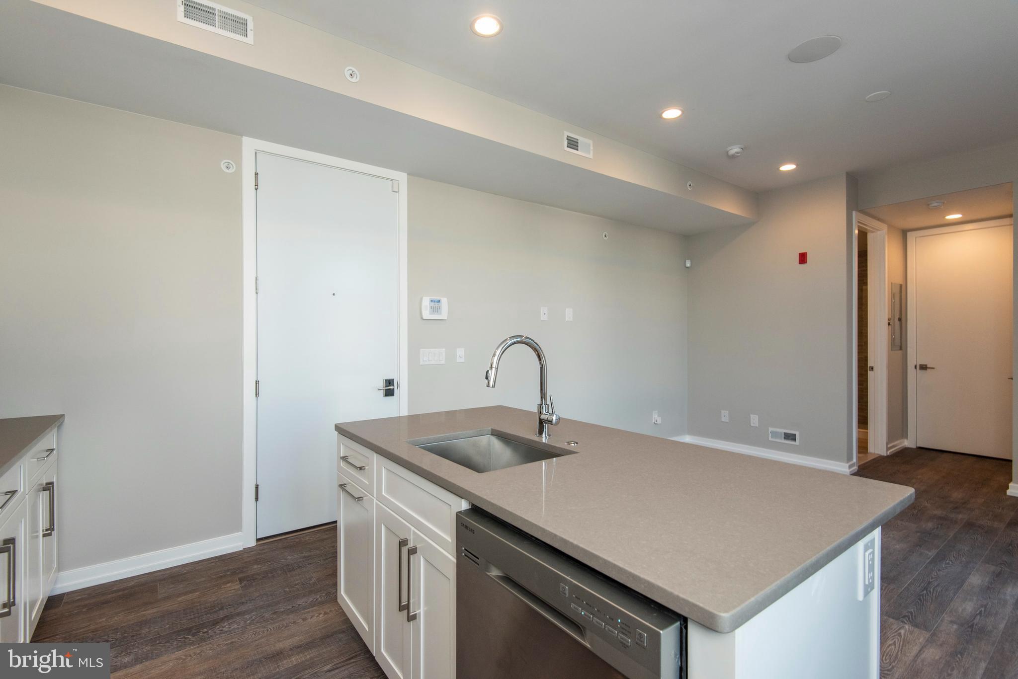 1340 South 13th Street, Unit 3B Philadelphia, PA 19147 - Photo 29 of 31 a view of kitchen island a sink wooden floor and entryway