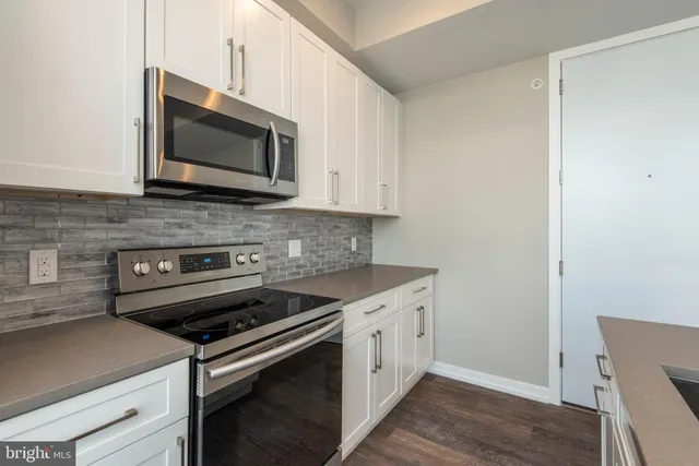 a kitchen with a stove microwave and sink