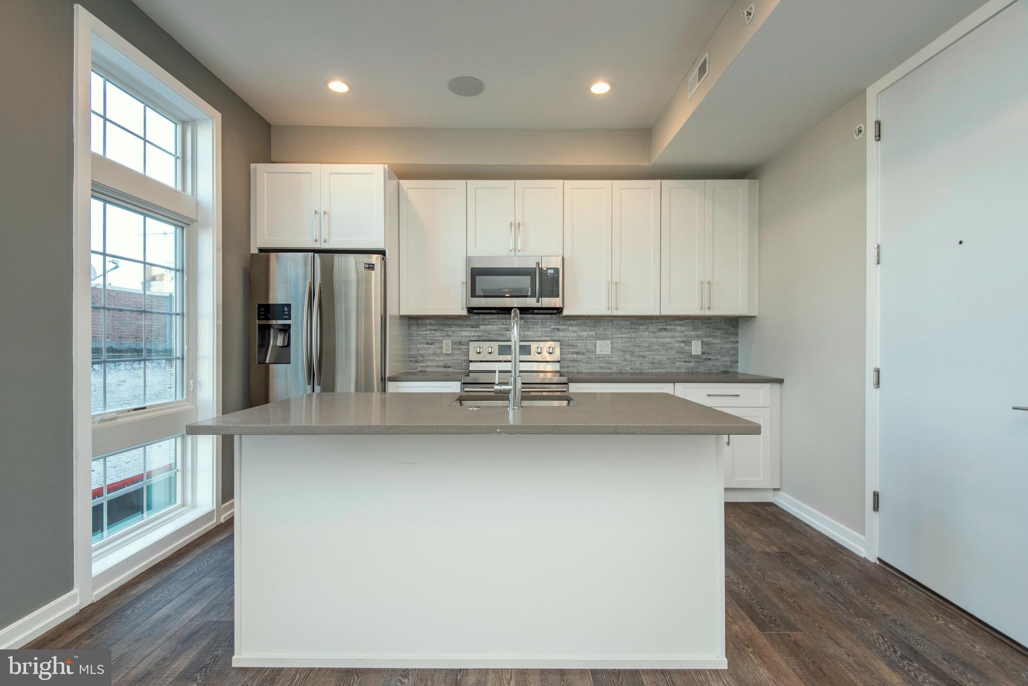 1340 South 13th Street, Unit 3B Philadelphia, PA 19147 - Photo 7 of 31 a kitchen with stainless steel appliances granite countertop a refrigerator sink and stove