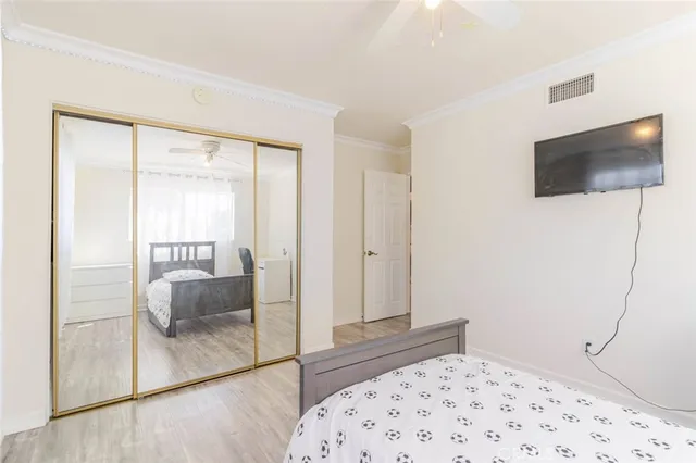 a bedroom with a bed and a television