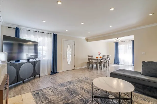 a living room with furniture and a dining table with kitchen view