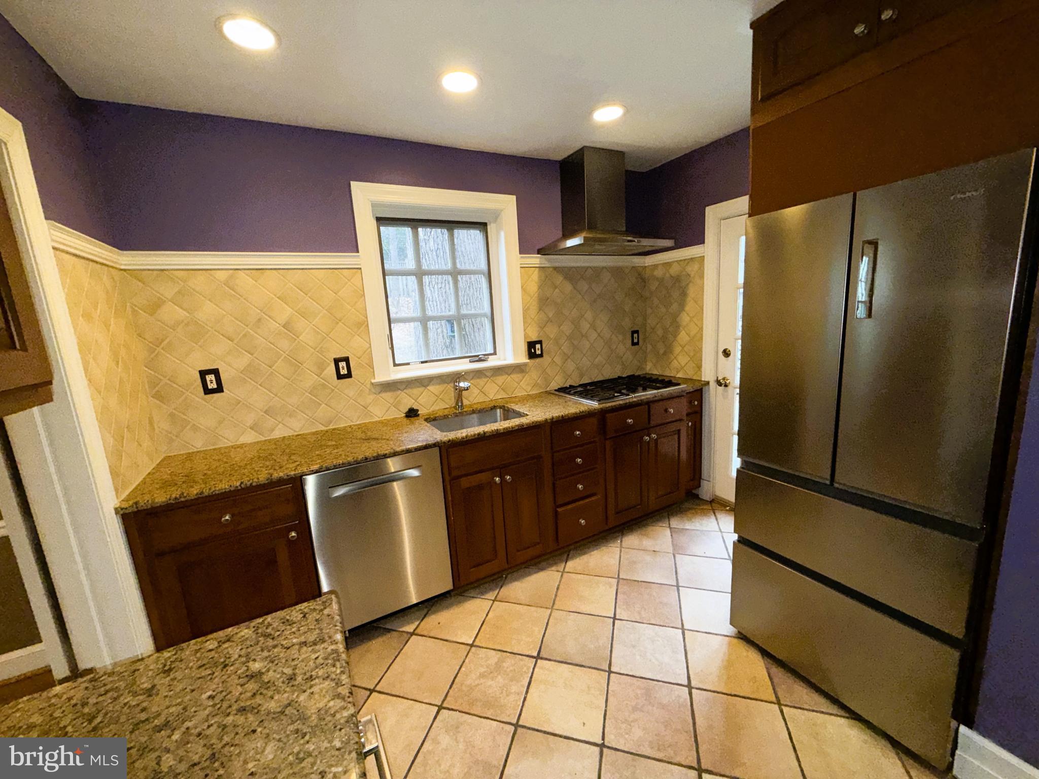 3202 Rolling Road Chevy Chase, MD 20815 - Photo 13 of 43 a kitchen with stainless steel appliances granite countertop a refrigerator and a sink