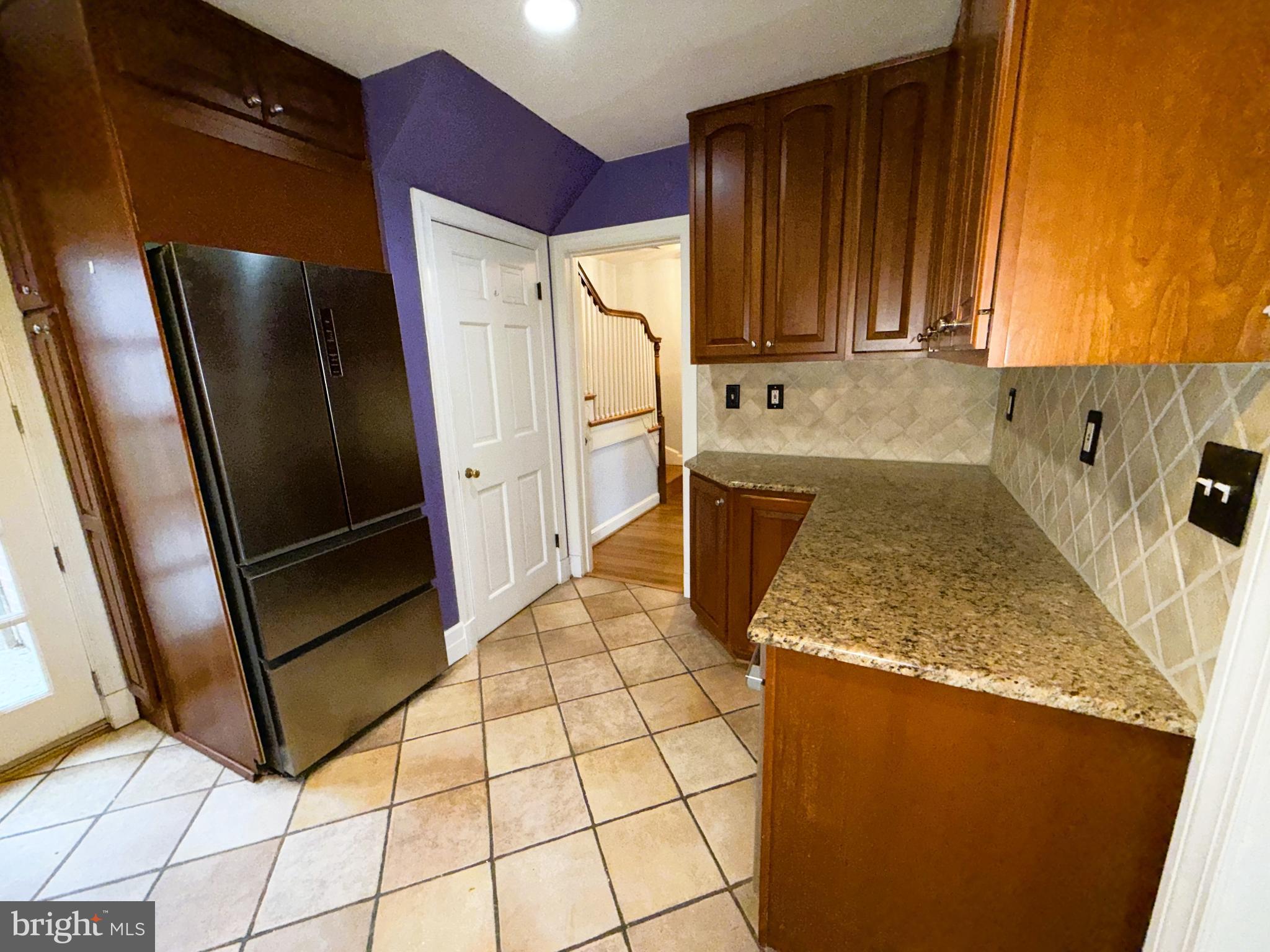 3202 Rolling Road Chevy Chase, MD 20815 - Photo 14 of 43 a kitchen with stainless steel appliances granite countertop a refrigerator a stove and a sink
