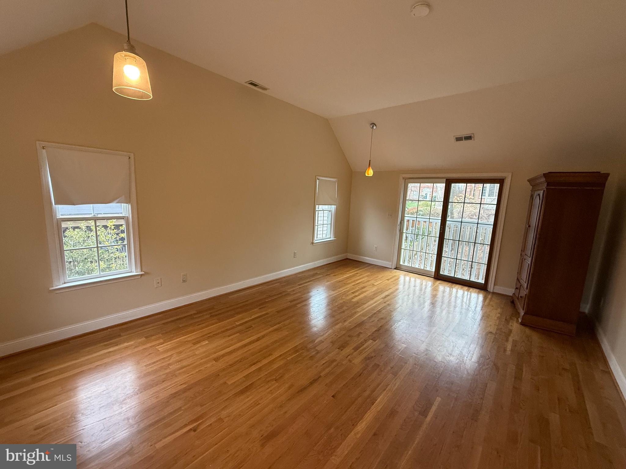 3202 Rolling Road Chevy Chase, MD 20815 - Photo 19 of 43 a view of an empty room with wooden floor and a window