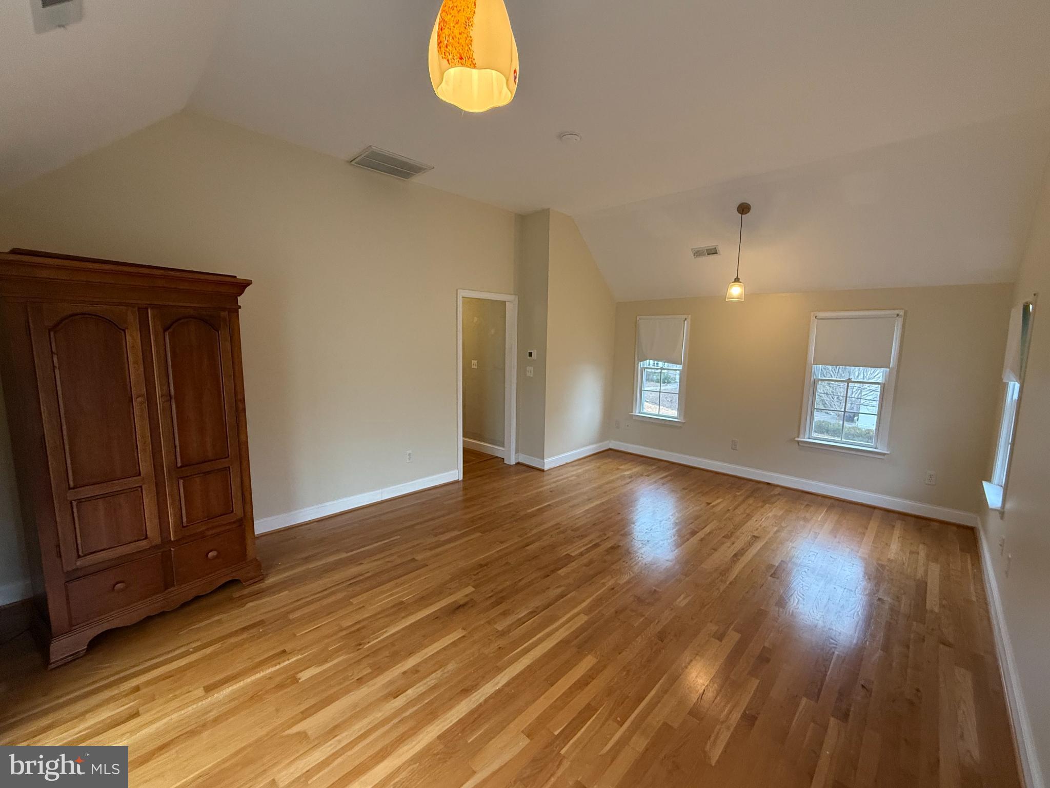3202 Rolling Road Chevy Chase, MD 20815 - Photo 20 of 43 an empty room with wooden floor and windows