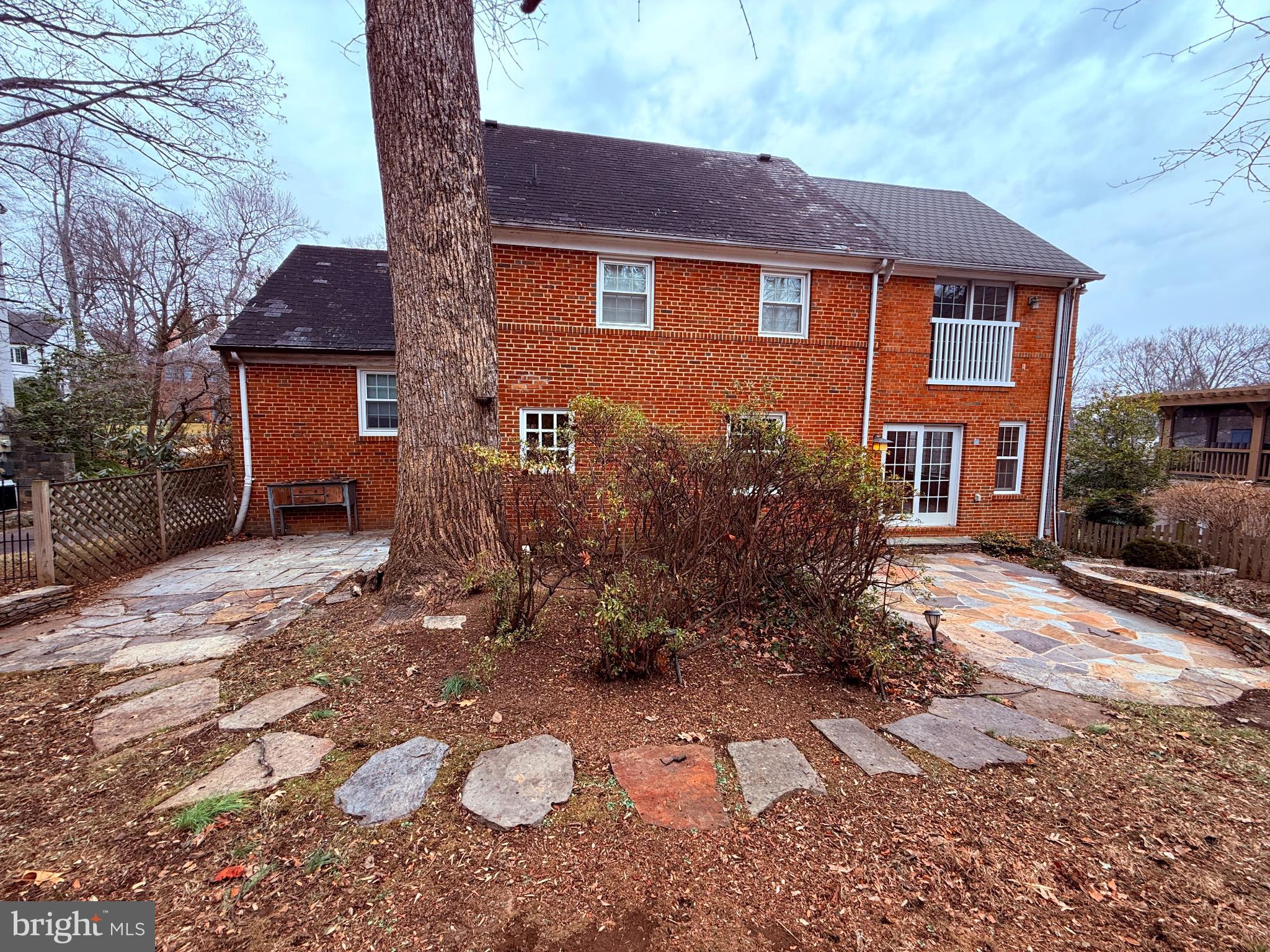 3202 Rolling Road Chevy Chase, MD 20815 - Photo 3 of 43 a brick house with a large tree in front of it