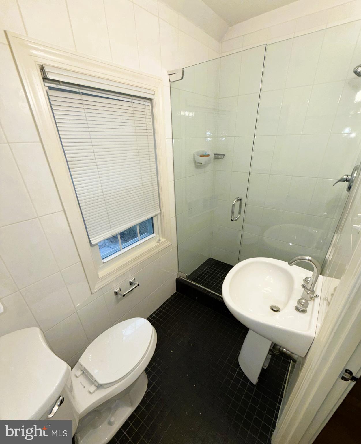 3202 Rolling Road Chevy Chase, MD 20815 - Photo 31 of 43 a bathroom with a toilet sink and a mirror