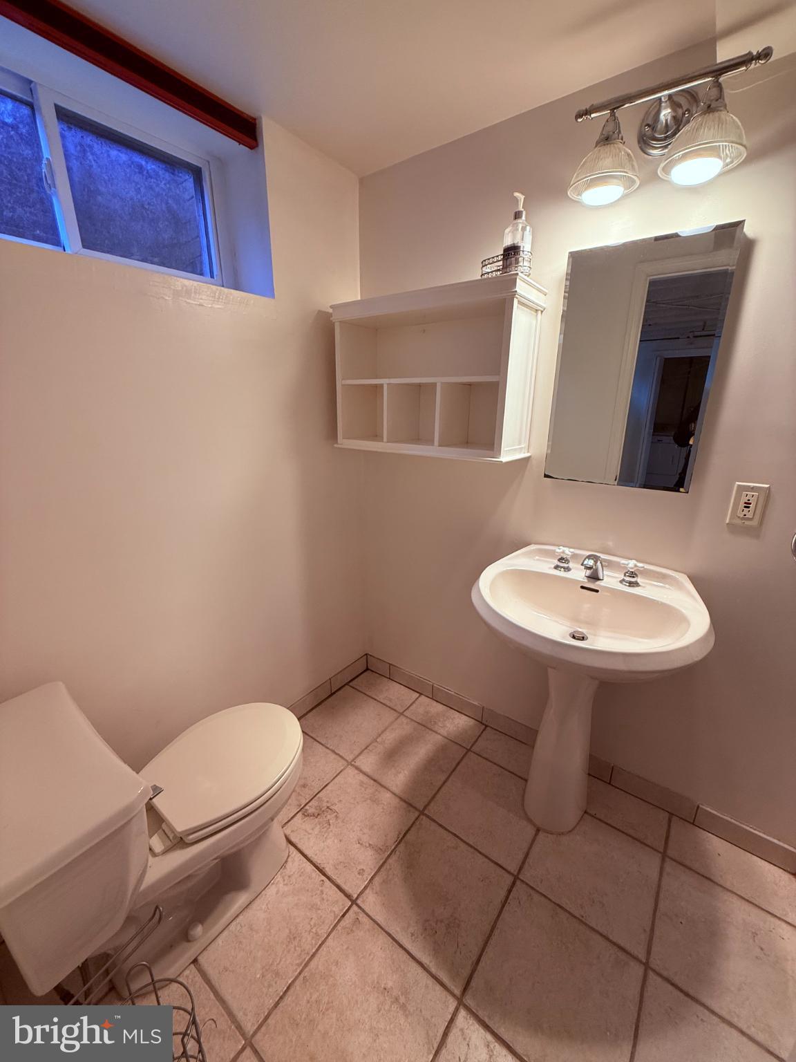 3202 Rolling Road Chevy Chase, MD 20815 - Photo 35 of 43 a bathroom with a sink a toilet a mirror and vanity