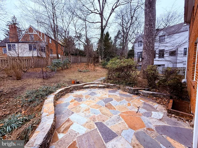 a backyard of a house with yard and trampoline
