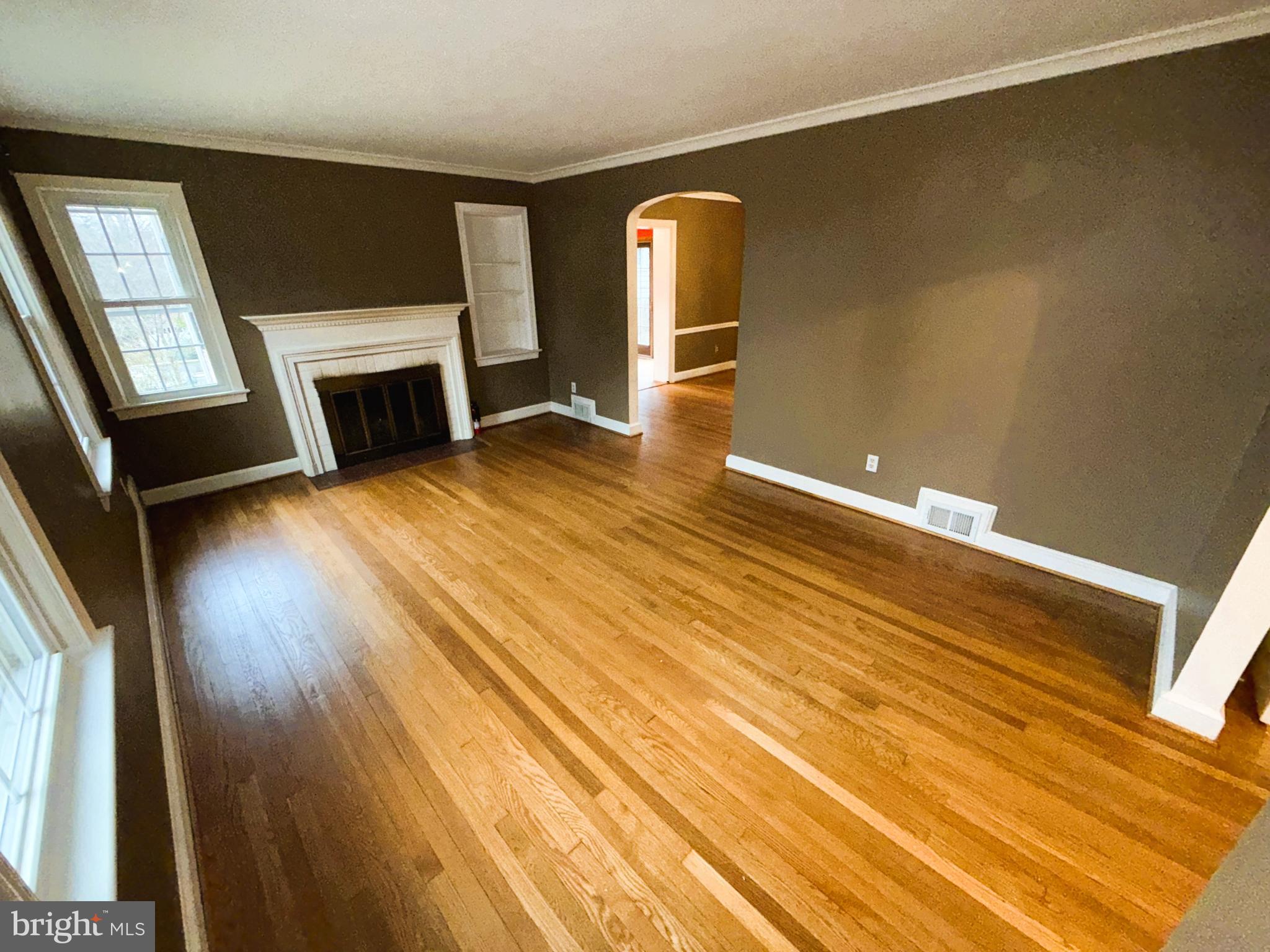 3202 Rolling Road Chevy Chase, MD 20815 - Photo 7 of 43 a view of empty room with fireplace and wooden floor
