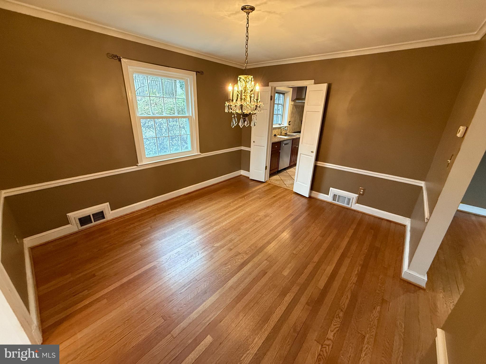 3202 Rolling Road Chevy Chase, MD 20815 - Photo 10 of 43 a view of a room with wooden floor and windows